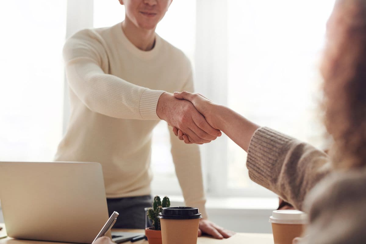 Two people at a desk reviewing paperwork together