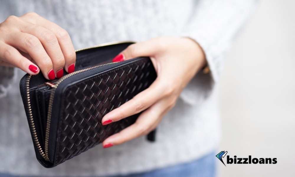 woman holding empty wallet