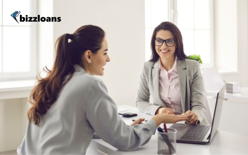 business woman talking to a female loan broker