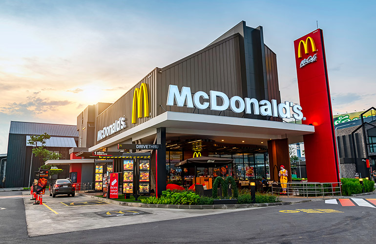 McDonald’s Restaurant with a black car in drive-thru window