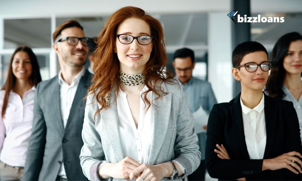 Group of happy employees walking in the office