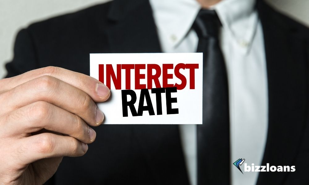 business man holding a paper with interest rate concept