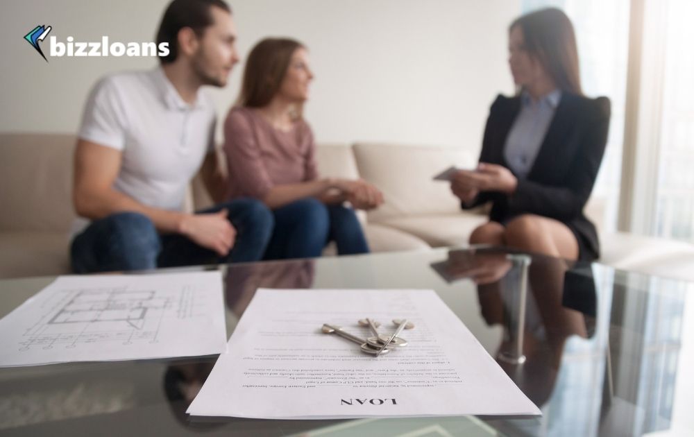 two business owners talking to a lender about getting a loan