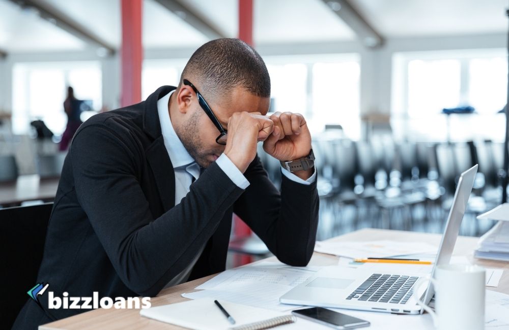 exhausted businessman at his desk 