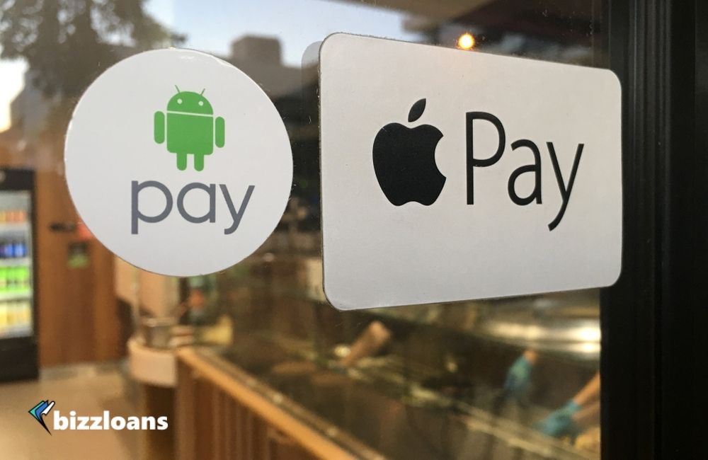 Apple and Android Pay stickers on a door to a restaurant which are two of the best mobile payment apps