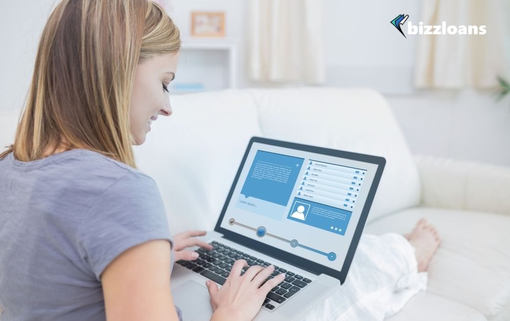 business woman who needs funds fot her business checking social media on her laptop