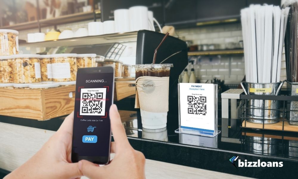 Man scanning Qr code payment in cashier, E wallet, cashless technology concept.