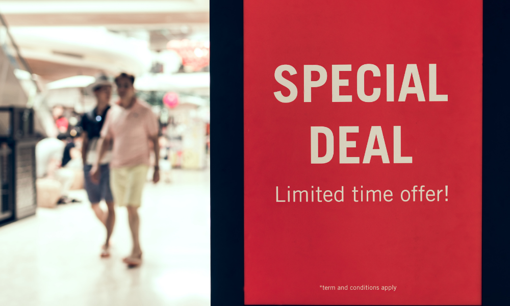 Special Deal poster in the shopping mall and two men walking