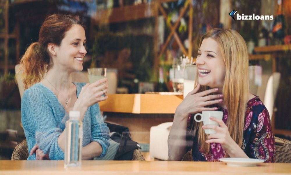 business owners talking and laughing in a cafe as one of the mental health tips