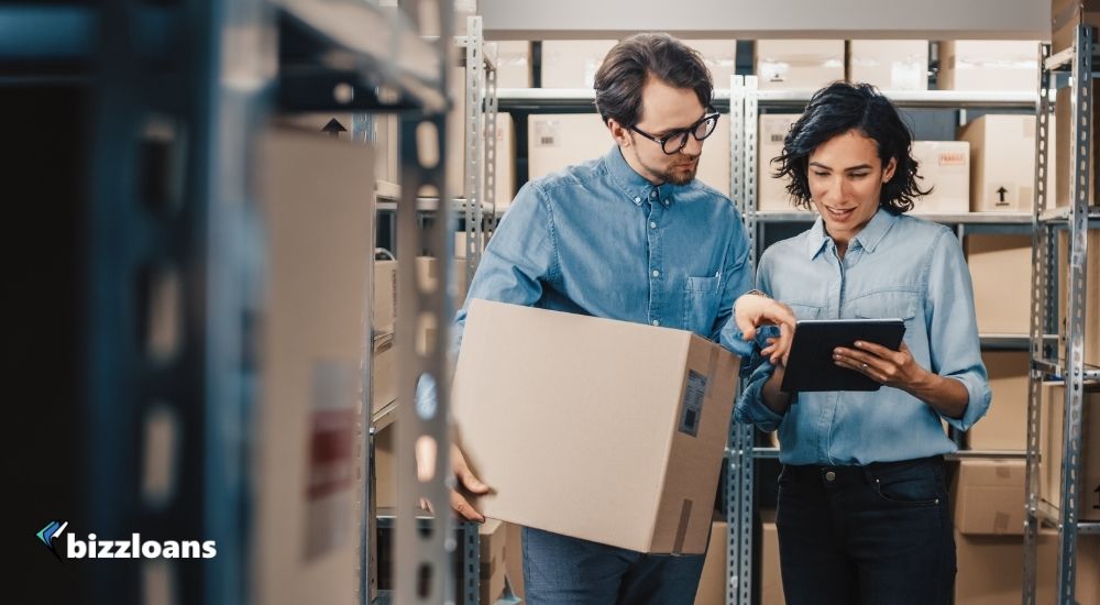 two business owners doing inventory management in a warehouse