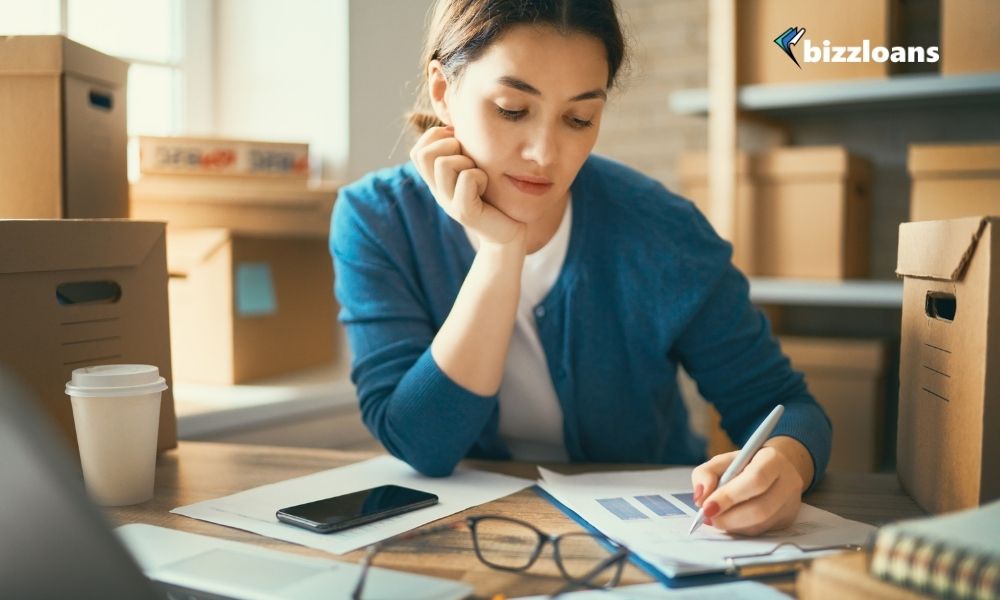 business woman writing down her plans for an inventory management