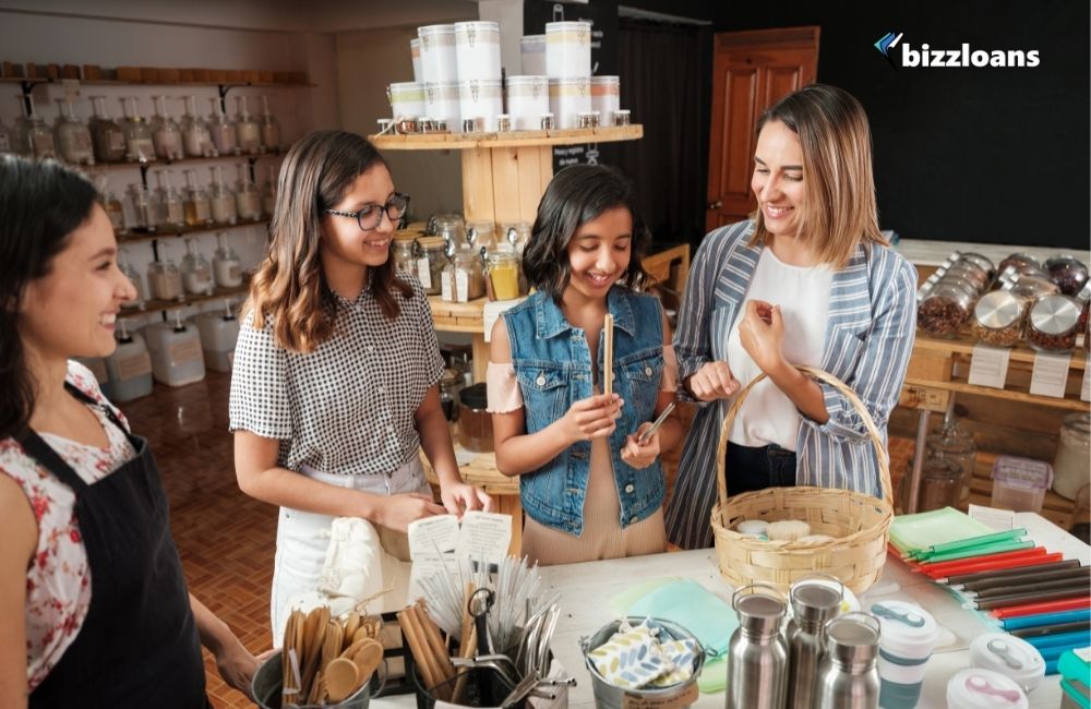 happy customers looking at a metal straw in a shop