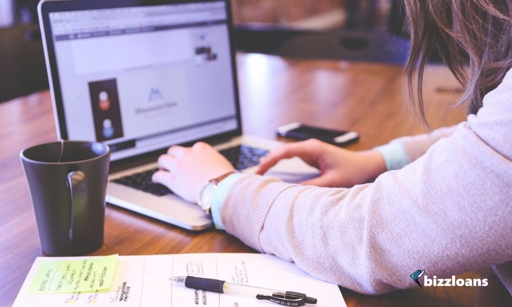 business owner planning her marketing on laptop