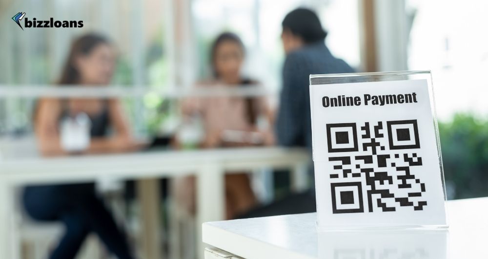 Online payment QR code for customer use sign with people eating in the background