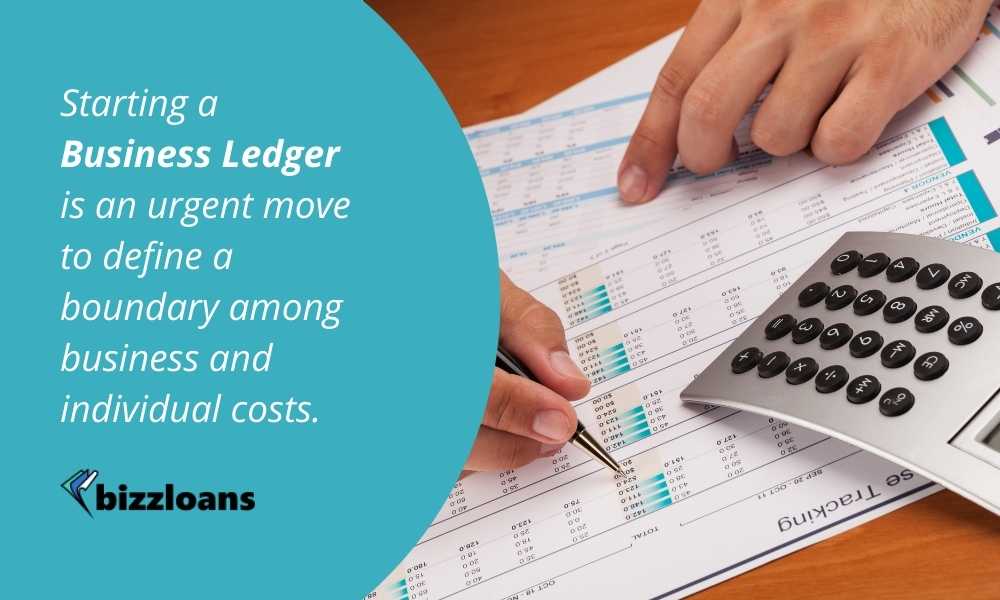 business man writing on ledger with calculator