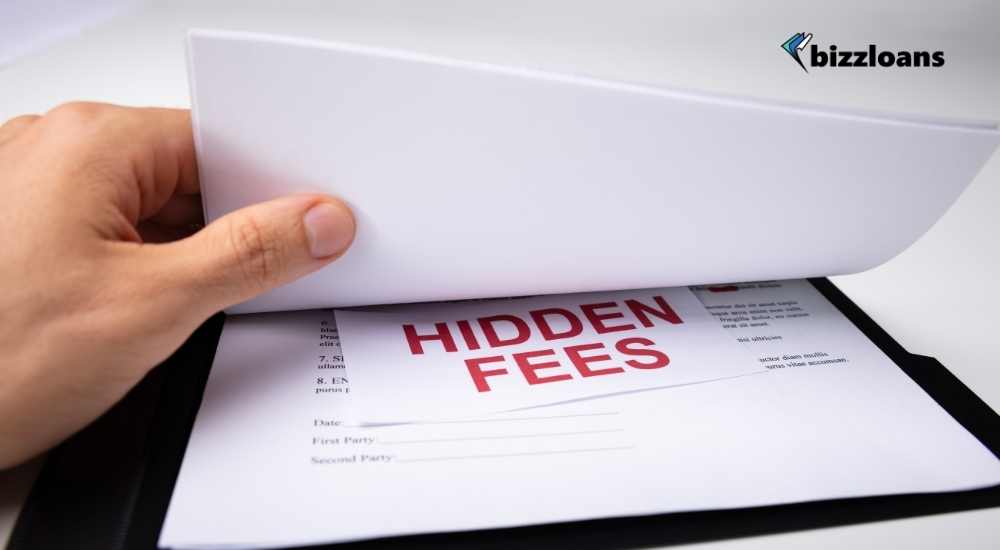 man holding a contract with the word "hidden fees" in between the papers