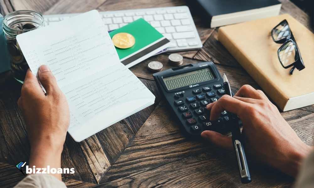 business man working with calculator to calculate expenses