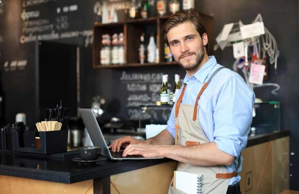 happy business owner on laptop