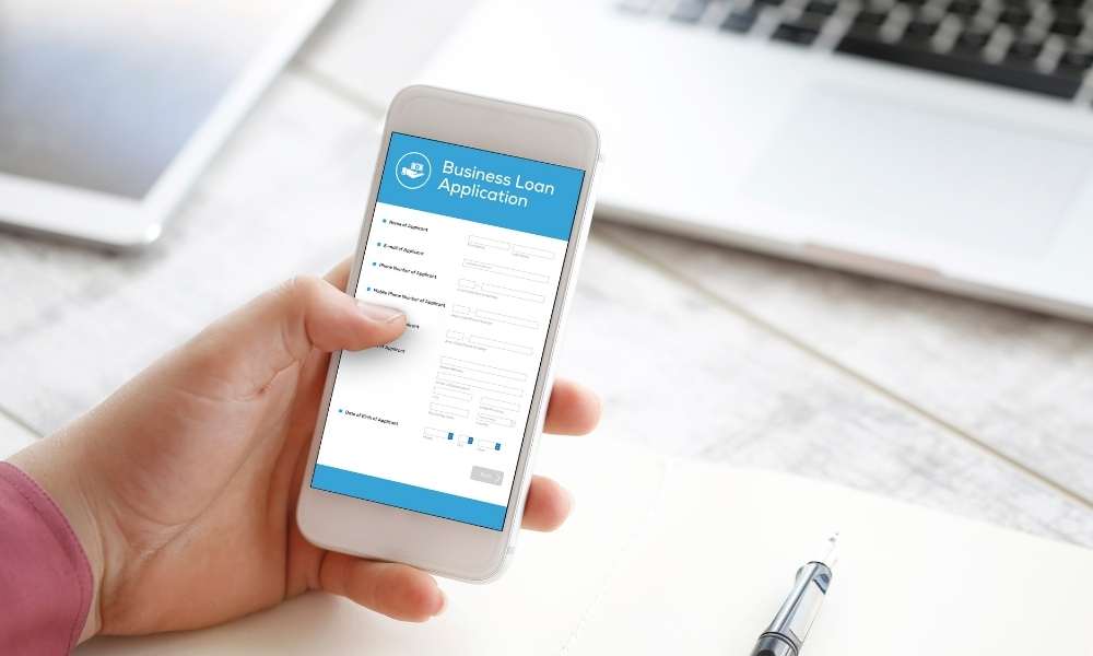 woman checking business loan application form on mobile