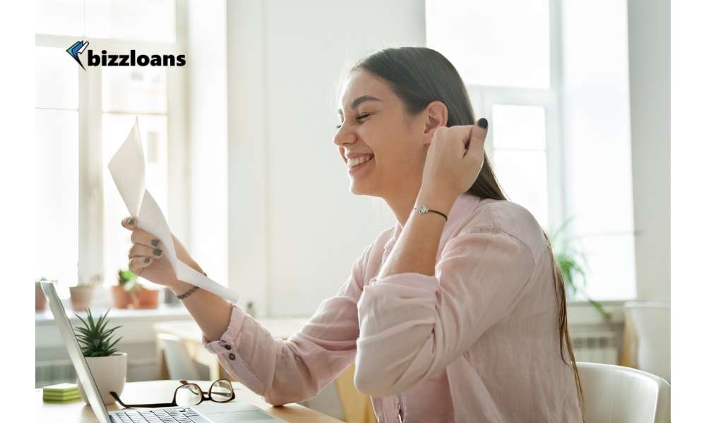 happy business woman reading a letter of approval for a short term loan