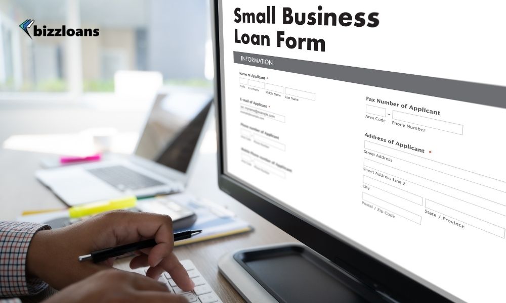 man filling up small business loan form online