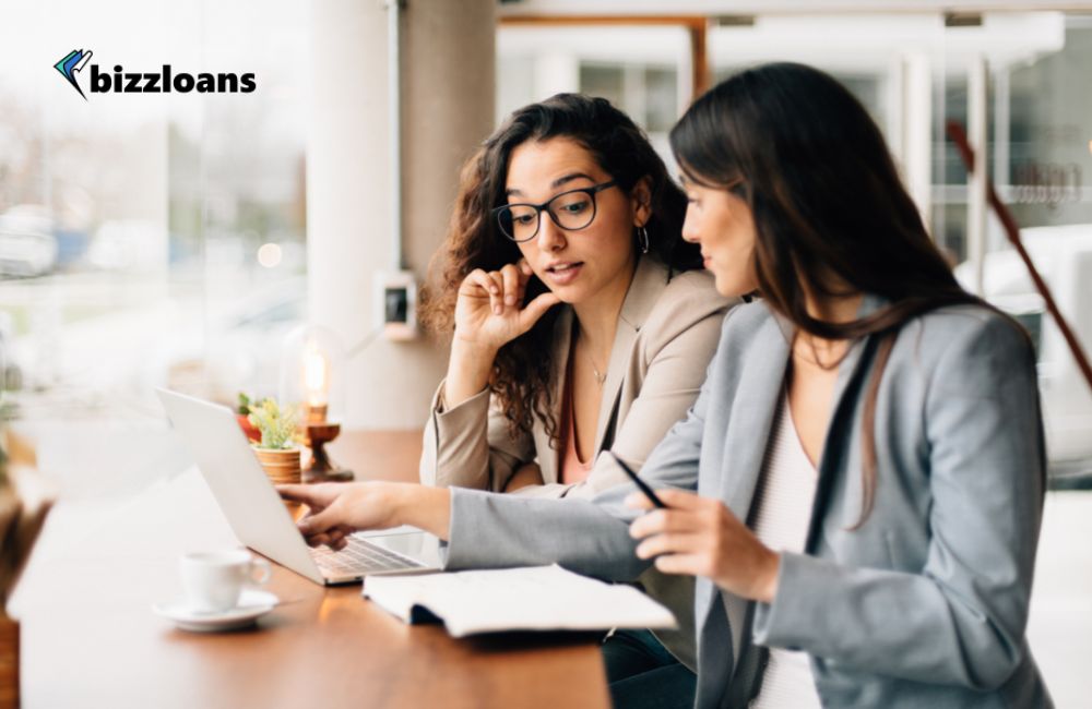 two female business owners discussing about the best small business lenders in australia in front of laptop